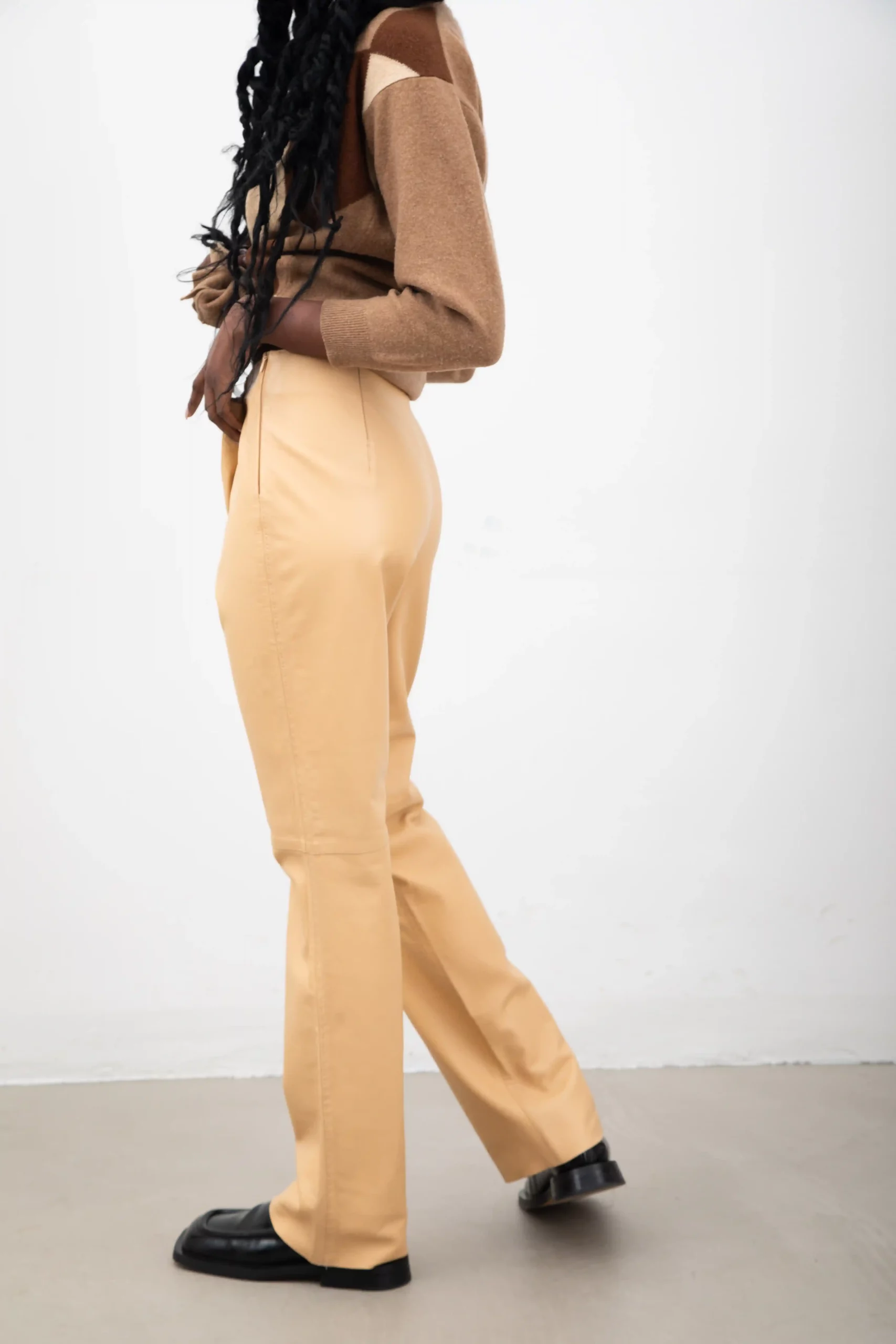 Soft beige leather pants by Antonio Fusco with hand-stitched embroidery at waist and sides. With invisible side zipper, and darts on the back.